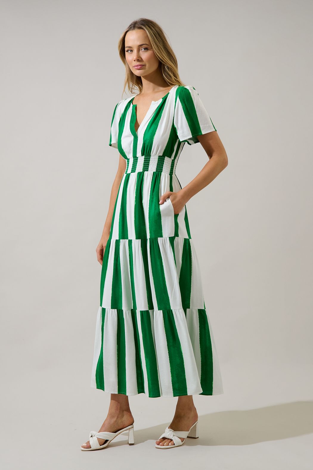Green and white striped maxi dress with a smocked waist, pockets, and a tiered skirt.   Comes lined with a v-neck. 