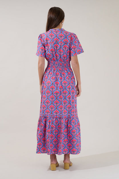 A women's short-sleeve maxi dress featuring an all-over damask floral print in cerulean red with an elastic smocked waistband, a split neck collar, and a tiered ruffle skirt.