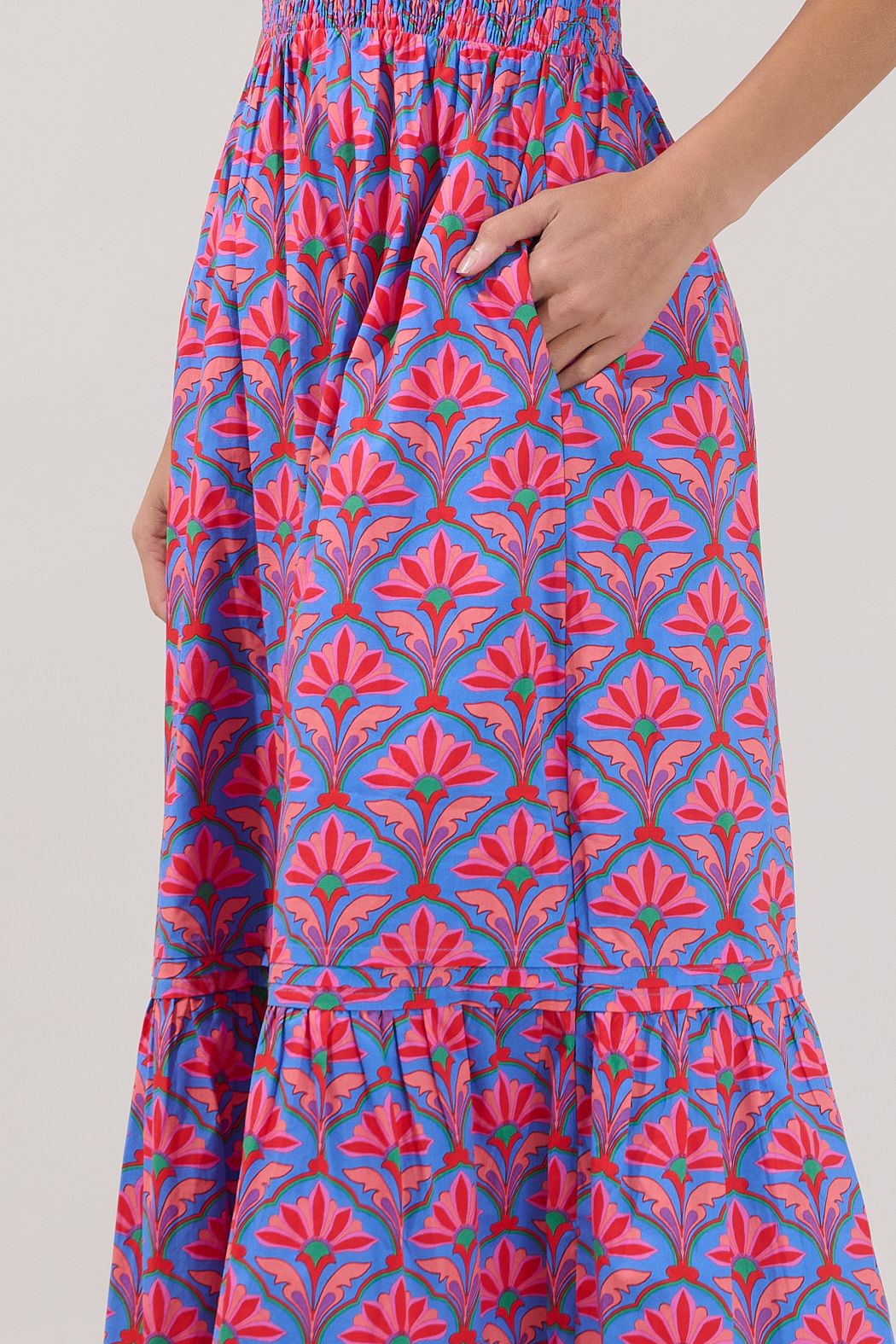 A women's short-sleeve maxi dress featuring an all-over damask floral print in cerulean red with an elastic smocked waistband, a split neck collar, and a tiered ruffle skirt.